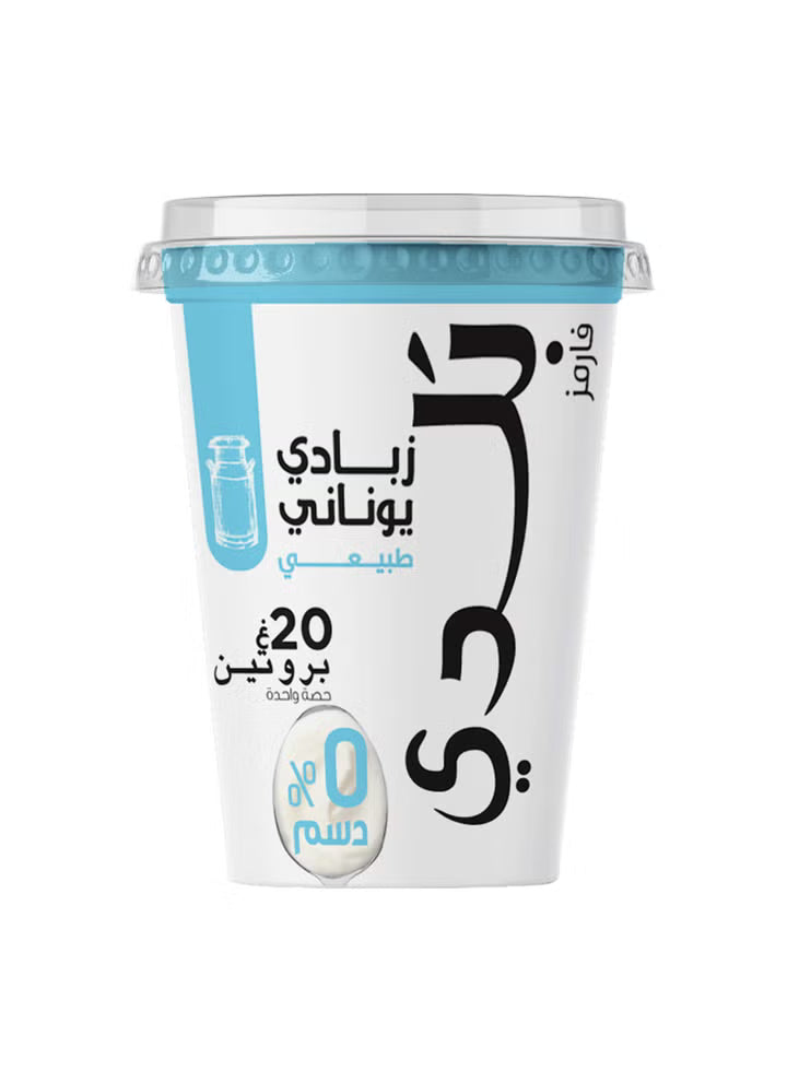 A white plastic cup of Camel brand yogurt with Arabic text, featuring a light blue label section and a clear lid, set against a plain white background.