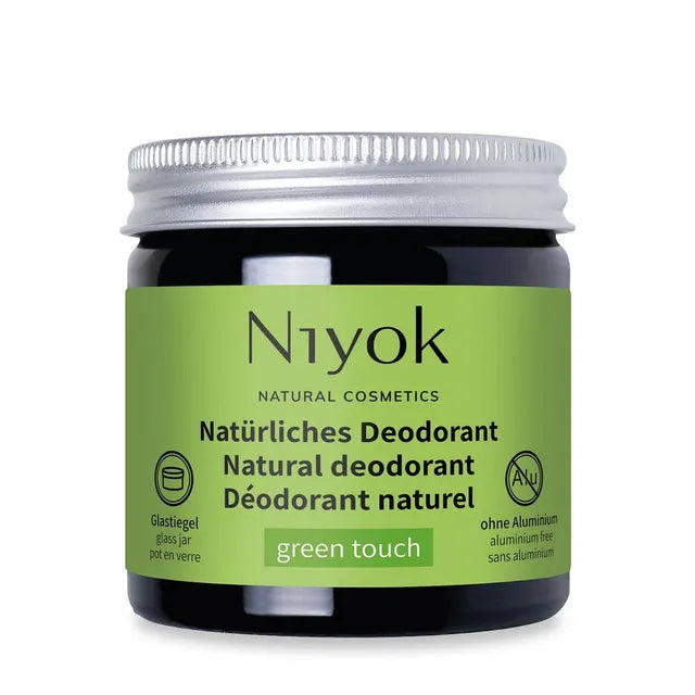 Niyok natural deodorant jar with green label on a white background
