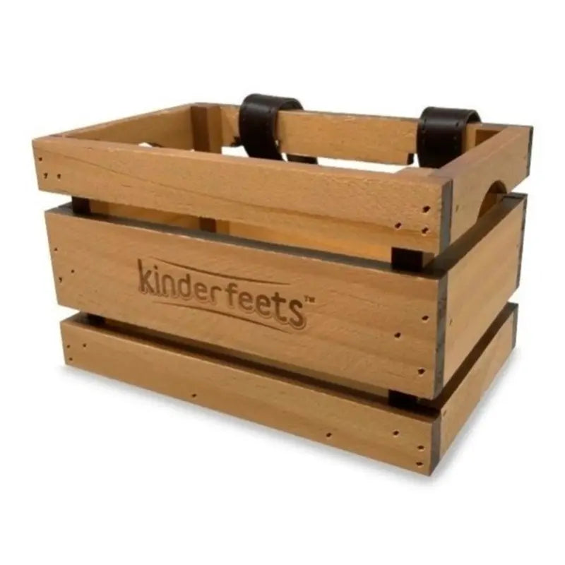 A wooden crate with a natural oak finish and black rubber feet, featuring the brand name 'kinderfeets' embossed on the front, set against a plain white background.
