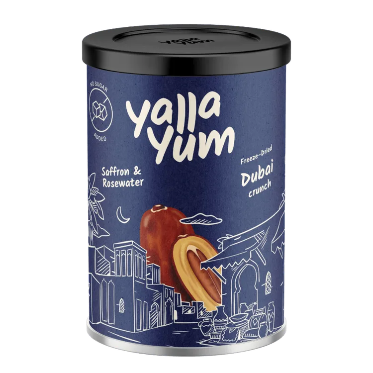 A cylindrical metal tin of Yalla Yum Dubai Crunch snack, featuring a dark blue label with white text, a drawing of a traditional Arabian building, and an illustration of a softron and rosewater snack piece. The tin has a black lid and is photographed on a solid white background.