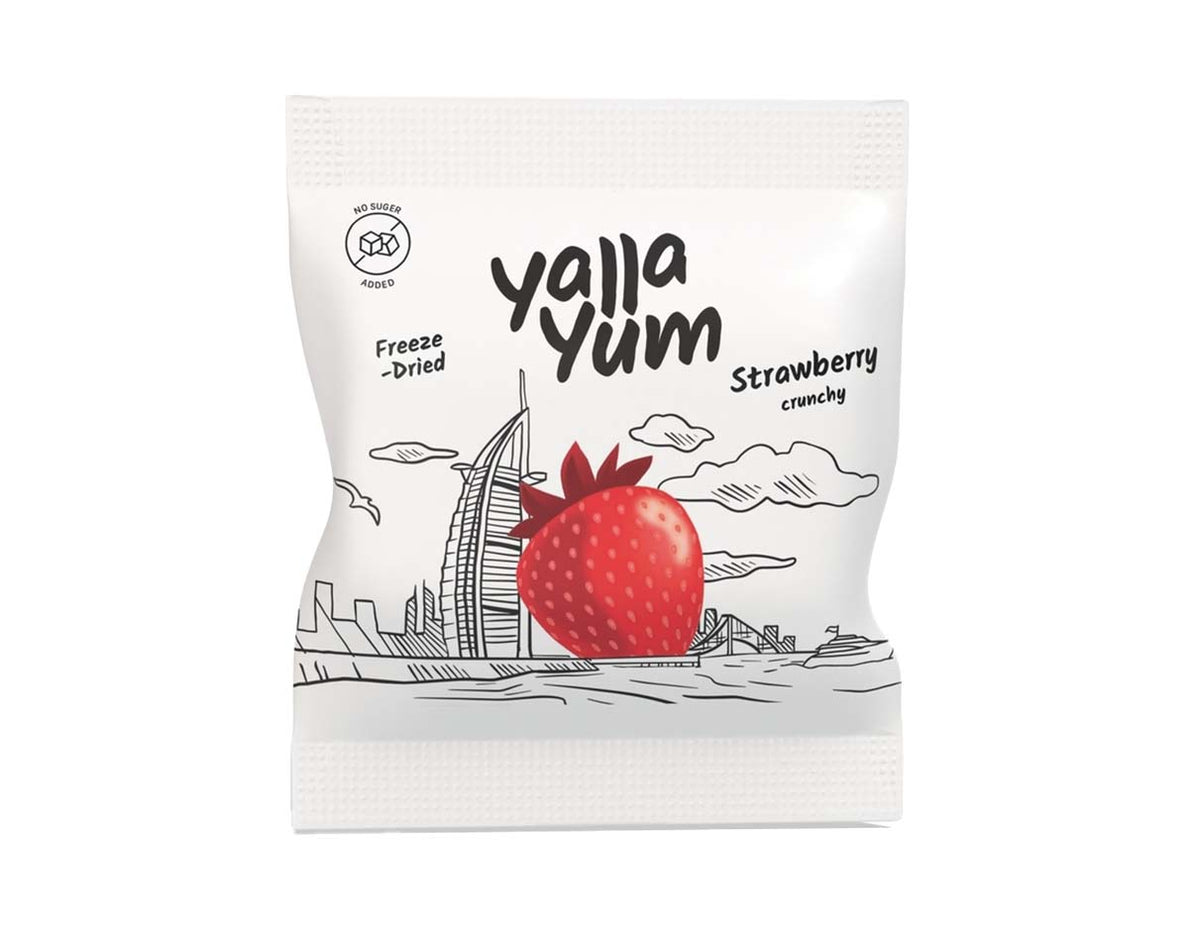 A package of Yalla Yum Strawberry Crunchy freeze-dried snacks, featuring a white bag with a black line-art illustration of the Burj Khalifa and a large red strawberry graphic in the center.