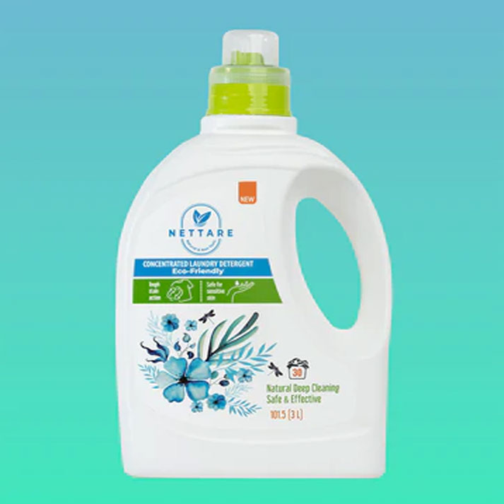 A 31L bottle of Nettare Concentrated Laundry Detergent against a teal gradient background. The bottle is white with a lime green cap and features blue and green floral graphics on the label.