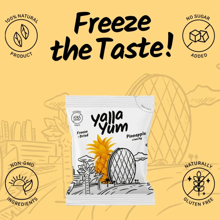 A package of Yajja Yum Freeze-Dried Pineapple Strawberrys on a warm yellow background with promotional text and icons for natural product, no sugar added, non-GMO, and gluten free.
