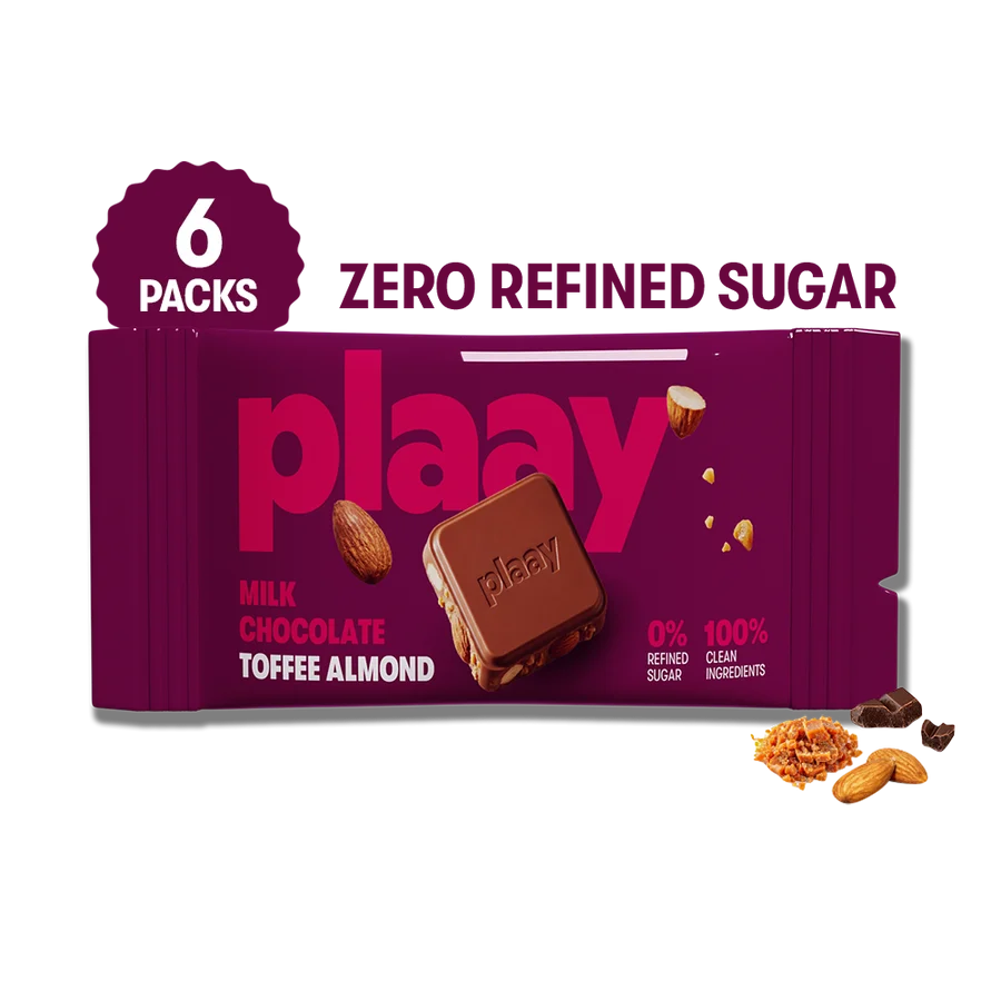 A package of six Playay milk chocolate toffee almond bars, featuring a deep magenta-purple wrapper with pink branding and a chocolate bar illustration. A circular badge on the top left reads '6 PACKS', and 'ZERO REFINED SUGAR' is printed at the top right.