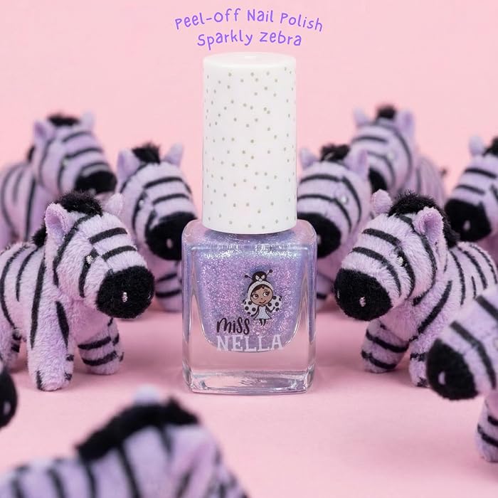 Nail polish bottle with 'Miss Mottle' branding in front of plush zebras on a pink background