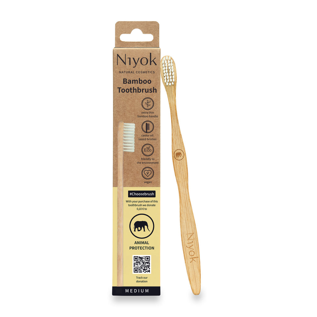 Niyok bamboo toothbrush with packaging on a white background