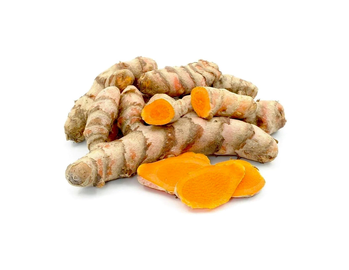 A pile of fresh turmeric roots with two sliced pieces showing bright orange interiors, photographed on a clean white background.