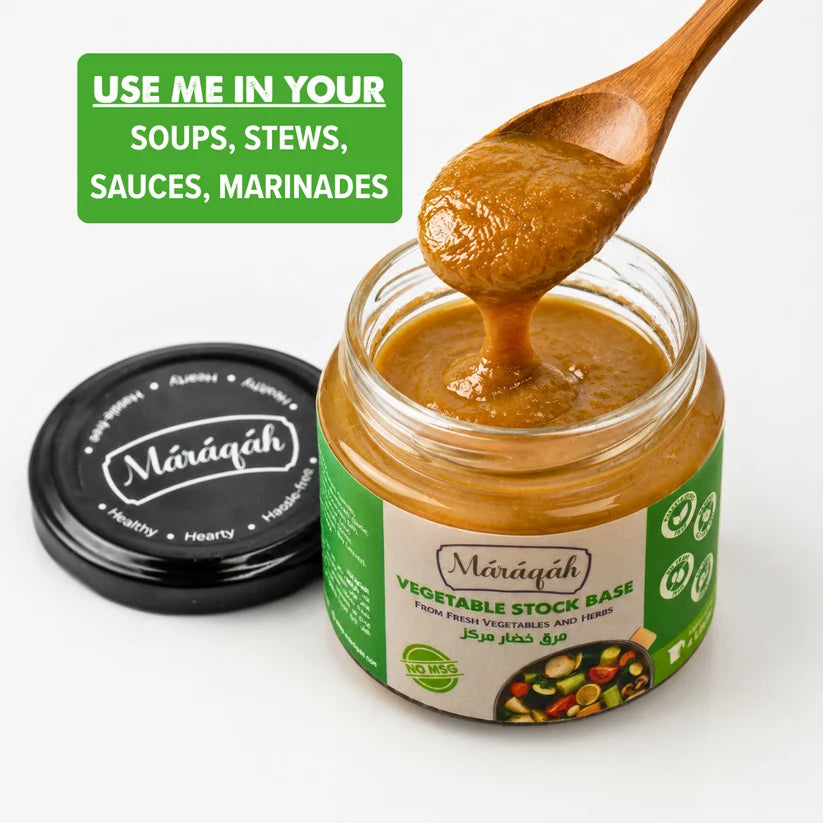 A jar of Mâāqah Vegetable Stock Base with a wooden spoon lifting the thick brown paste, shown next to its black lid on a white background with a green usage tip banner.