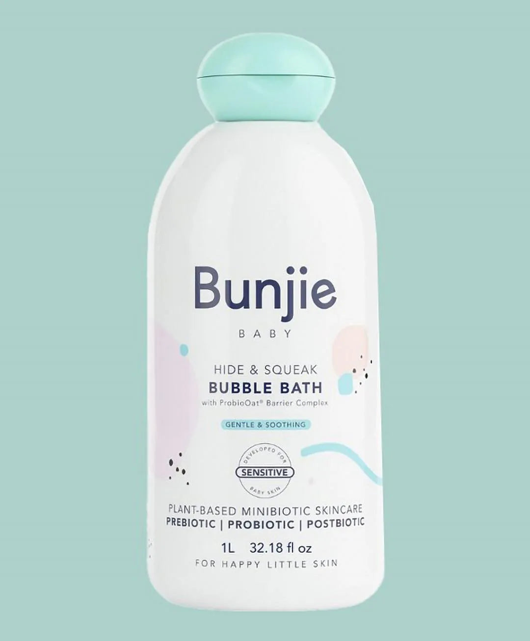 A 1L bottle of Bunjie Baby Hide & Squeak Bubble Bath on a solid light teal background. The bottle is white with a light teal cap and features the brand name 'Bunjie' in dark blue text, along with light pastel pink and blue graphic accents.