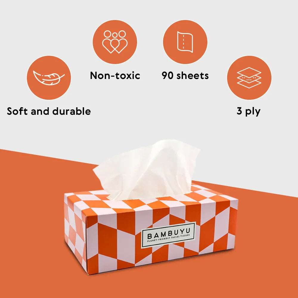 A tissue box cover with a white and orange geometric pattern, featuring a white tissue protruding from the top. The packaging has a visible label reading BAMBUYU.