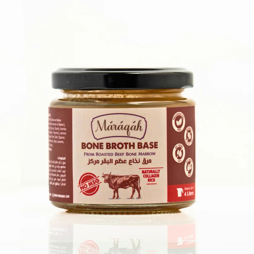 A jar of Mâráqáh Bone Broth Base, featuring a brown and white label with a black lid, set against a clean white background with a subtle reflection.