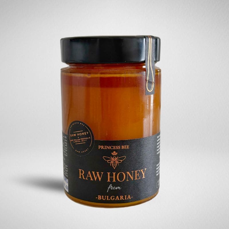 A glass jar of Princess Bee Raw Honey from Bulgaria, featuring a black lid with a metal clamp and a black label with gold lettering, set against a light gray background.