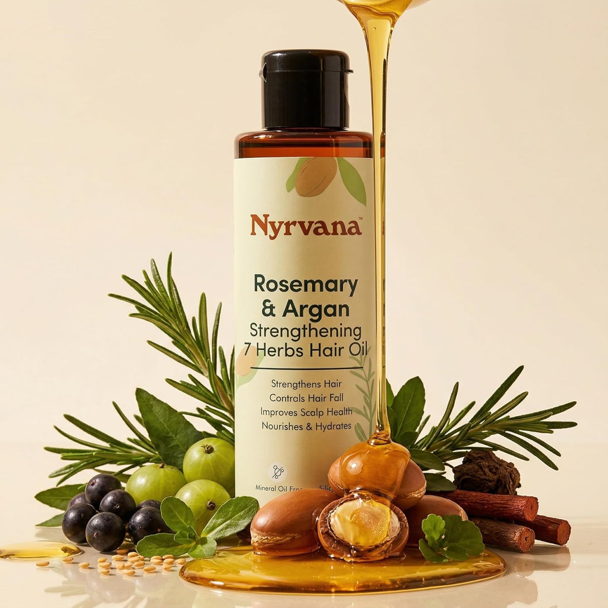 A bottle of Nyrvana Rosemary & Argan Strengthening 7 Herbs Hair Oil is shown with a stream of golden honey dripping into a glass dish, surrounded by natural ingredients including rosemary, green and black grapes, acorns, cinnamon, and mint on a warm beige background.