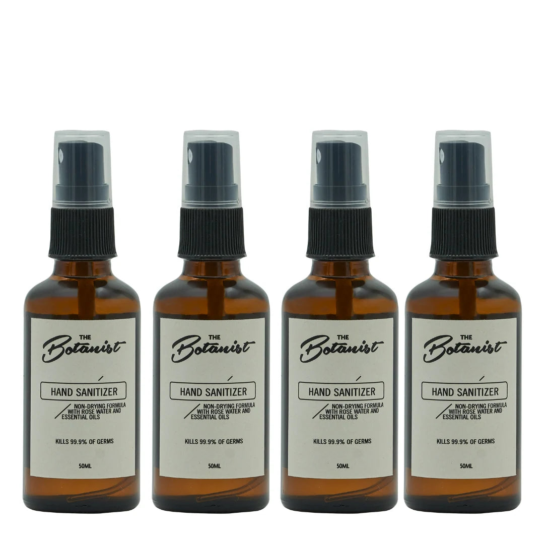 Four bottles of 'The Botanist' hand sanitizer on a white background