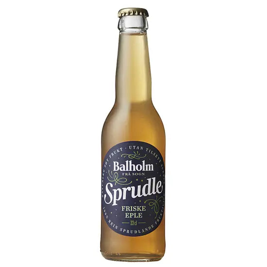 A glass bottle of Baltholm Sprudle Friske Eple beer, showing the golden-amber liquid inside, with a dark navy blue label and a gold crown cap, isolated on a white background.